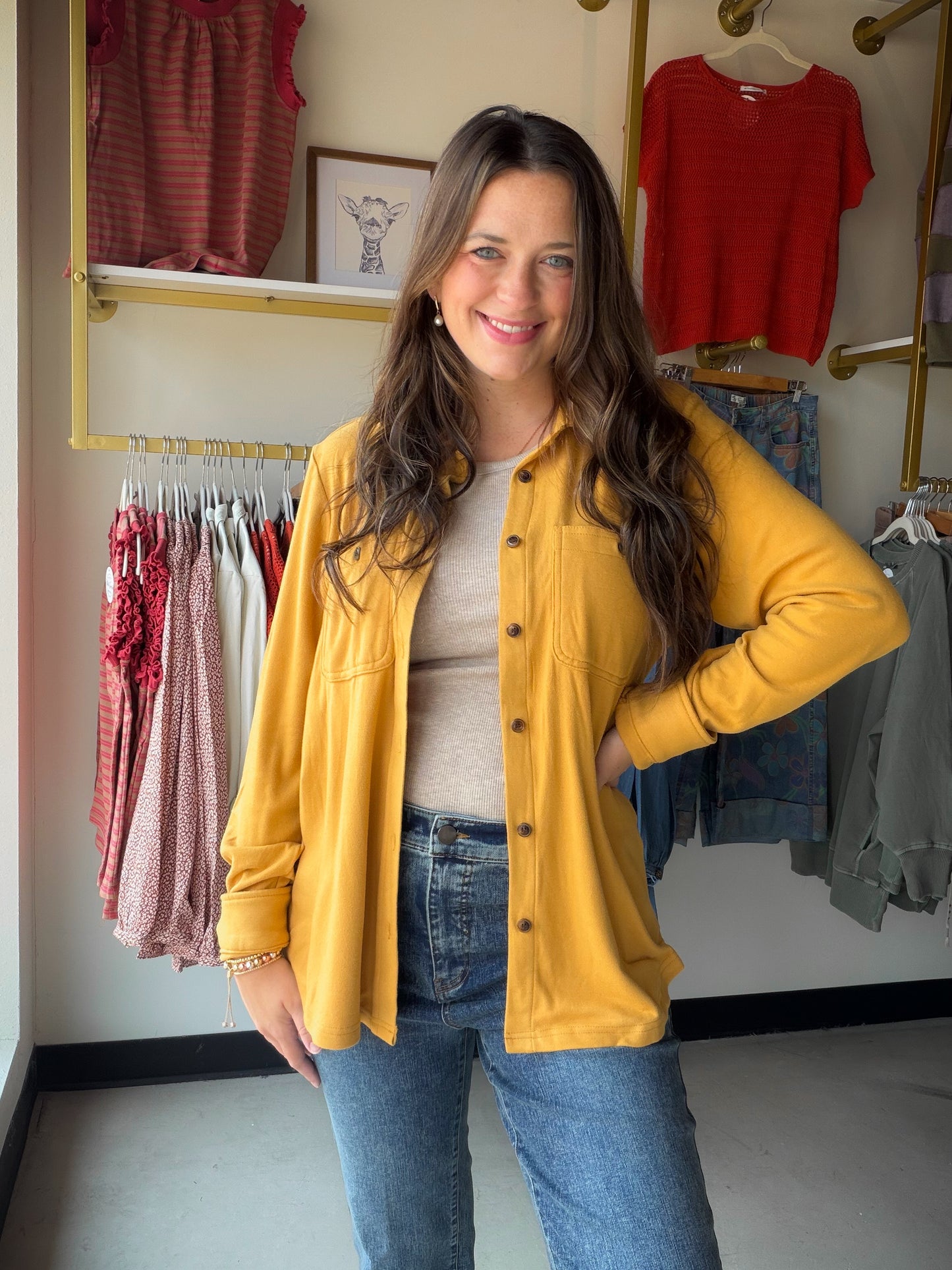 Cozy meets chic. The Mustard Butter Soft Button Up lives up to its name — the Rayon/Acrylic/Spandex blend is incredibly soft and drapes beautifully, making it one of those tops you'll want to live in. The warm mustard hue is a fall-ready neutral that pairs effortlessly with denim, trousers, or layered under a vest.

Long sleeve button-front silhouette
Two front bust pockets
Butter-soft fabric with a relaxed drape
75% Rayon / 15% Acrylic / 10% Spandex
Warm mustard colorway — a versatile seasonal staple
