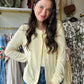 Experience comfort and style with this pastel yellow sweater cardigan, crafted from buttery soft material for a gentle touch against your skin. Featuring fully functioning front buttons, it offers versatile wear options, while ribbed cuff details add subtle texture and a refined finish. The beautiful pastel yellow hue brings a fresh, elegant pop of color to any wardrobe, perfect for layering in cooler weather.