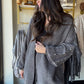 Umgee

Wrap yourself in cozy charm with the Charcoal Pearl Sleeve Cardigan. This playful open-front piece features delicate pearl buttons and long sleeves that add a touch of elegance to your everyday look. Perfect for layering, it effortlessly blends comfort with style, making it your new go-to for cooler days and casual outings.
