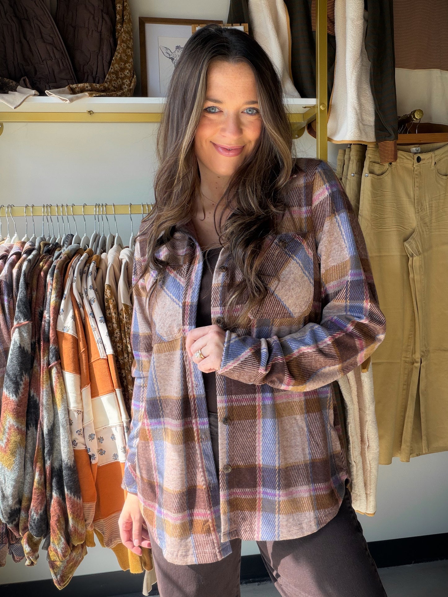 The perfect transitional layer has arrived. This cozy plaid shacket from&nbsp;Panache combines a warm tan base with a pop of periwinkle for a color combo that’s anything but basic. Soft, stretchy, and endlessly versatile — wear it open over a tee or buttoned up as a standalone top.

Eye-catching tan &amp; periwinkle plaid pattern — a fresh, boutique-exclusive colorway
Soft knit fabric with a comfortable stretch: 68% Polyester / 28% Rayon / 4% Spandex
Relaxed, layerable silhouette that works as a shacket or 