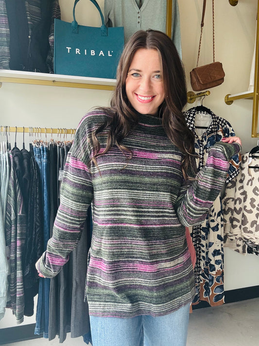 Tribal

Wrap yourself in cozy charm with the Pink Flambe Mock Neck sweater. Its super soft striped fabric feels like a gentle hug, while the playful mock neckline adds a touch of fun flair. Perfect for layering, it pairs beautifully with a vest to keep you warm and stylish on chilly days.