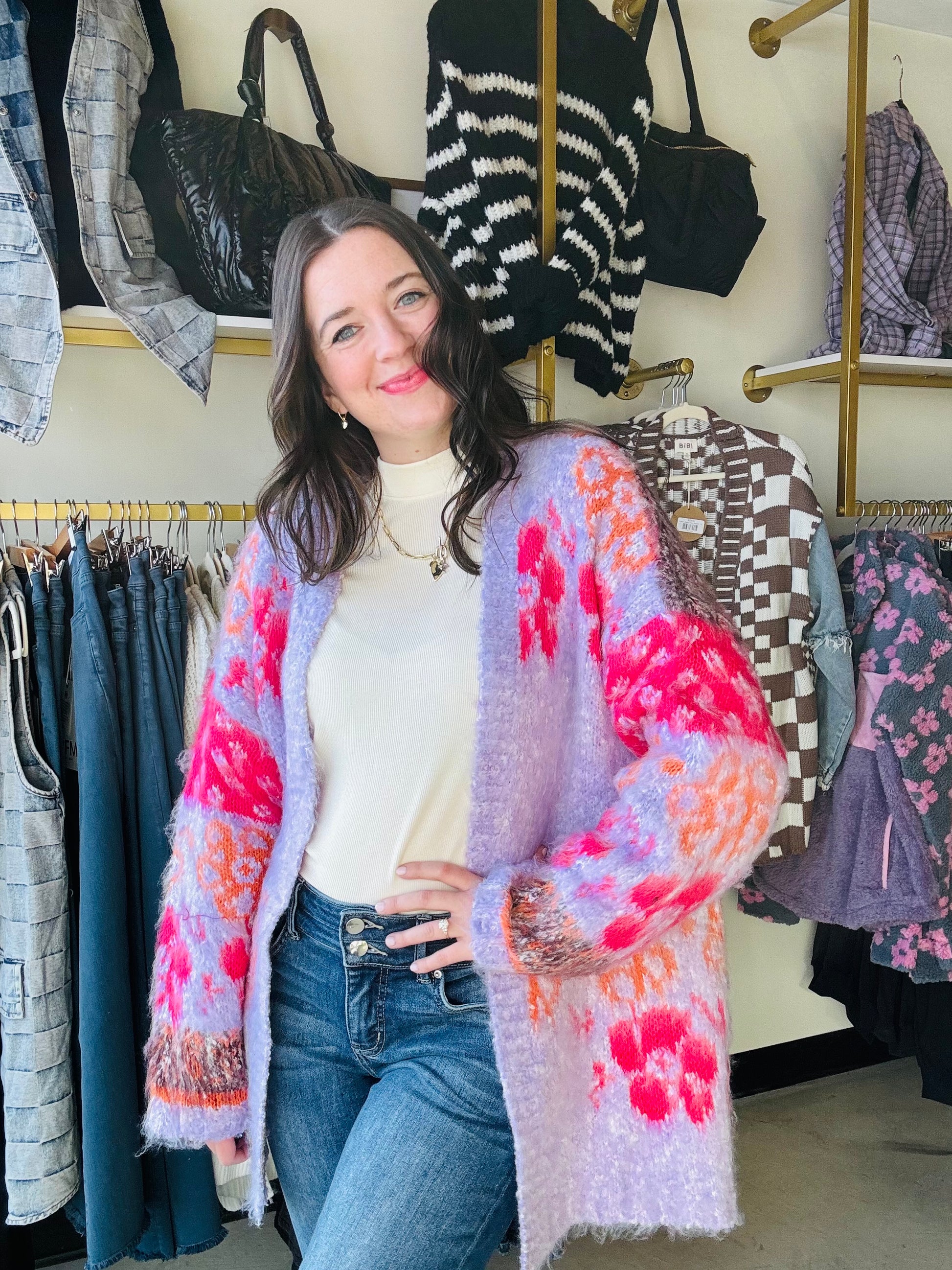 Wrap yourself in the cozy comfort and whimsical charm of our Pink Motif Fuzzy Cardigan. The oversized floral knit adds a playful touch while the open-front silhouette and ribbed hemlines provide a relaxed fit. With drop shoulder long sleeves and a fuzzy textured knit, this cardigan is the perfect addition to your wardrobe.