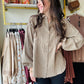 This Olive Grey Gauze Button Up features a lightweight cotton gauze fabric with a relaxed, boxy silhouette for breathable comfort. Designed with dropped shoulders, a collared neckline, and a button-down closure, it offers easy layering and effortless style. The shirt includes raw cut, frayed seams, button cuffs, and a front chest pocket for subtle detailing. Mini polka dot prints add refined texture, while the rounded hem enhances its modern, loose fit—perfect for a casual yet polished look.

Easel