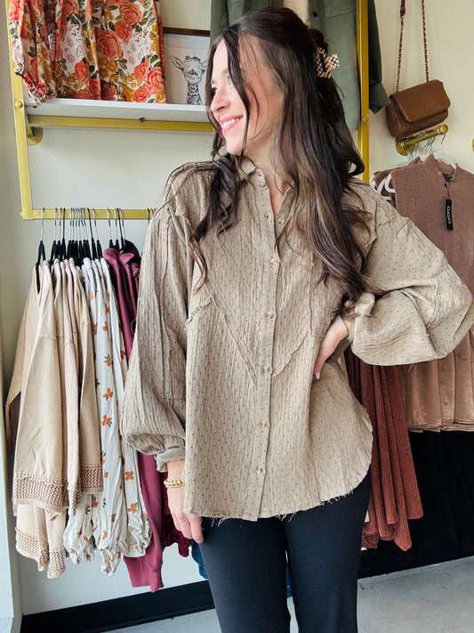 This Olive Grey Gauze Button Up features a lightweight cotton gauze fabric with a relaxed, boxy silhouette for breathable comfort. Designed with dropped shoulders, a collared neckline, and a button-down closure, it offers easy layering and effortless style. The shirt includes raw cut, frayed seams, button cuffs, and a front chest pocket for subtle detailing. Mini polka dot prints add refined texture, while the rounded hem enhances its modern, loose fit—perfect for a casual yet polished look.

Easel
