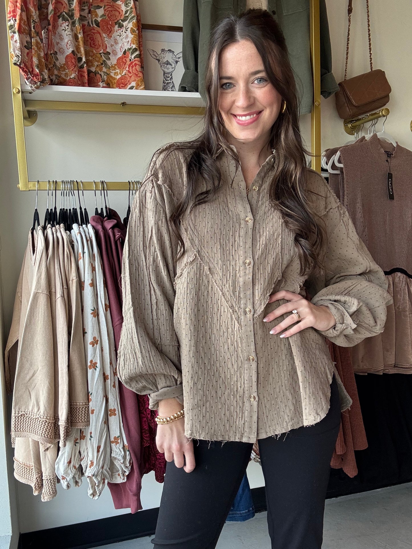This Olive Grey Gauze Button Up features a lightweight cotton gauze fabric with a relaxed, boxy silhouette for breathable comfort. Designed with dropped shoulders, a collared neckline, and a button-down closure, it offers easy layering and effortless style. The shirt includes raw cut, frayed seams, button cuffs, and a front chest pocket for subtle detailing. Mini polka dot prints add refined texture, while the rounded hem enhances its modern, loose fit—perfect for a casual yet polished look.

Easel