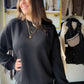 The kind of black pullover you'll want close at hand when the day calls for easy dressing. This Rae Mode crewneck brings a clean, versatile look to coffee runs, casual plans and quiet afternoons. Wear it with denim for an effortless outfit or pair it with your favorite relaxed bottoms.

Details to love

Classic black crewneck style
Pullover sweatshirt silhouette
Available in Small, Medium and Large
Fabric

48% modal, 45% polyester, 7% spandex. Rae Mode style T0123.