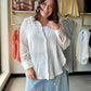 Effortlessly polished, endlessly versatile. The White Gauze Button Up (Aurelia Wrap Shirt) by Rain + Rose is a lightweight 100% rayon top that strikes the perfect balance between structured and relaxed. A crisp collar, long sleeves, and exaggerated cuffs give it a refined feel, while the wrap-tie front keeps things feminine and figure-flattering.

Wear it tucked into high-waisted denim, tied at the waist over a slip skirt, or left open as a breezy layer over a tank — this one does it all.

Crisp collar with