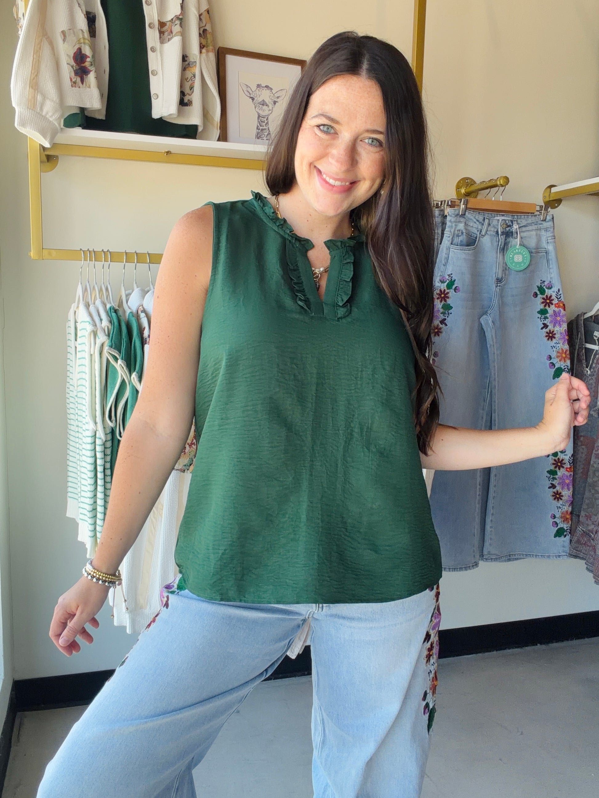Effortlessly feminine and ready for anything, the Forest Ruffle Detail Sleeveless Top by Staccato is the kind of piece you'll reach for again and again. A rich forest green hue pairs with delicate ruffle detailing for a look that feels polished without trying too hard.

The sleeveless silhouette keeps things cool and versatile — tuck it into your favorite trousers for the office, or style it with denim for a weekend out. Light, flowy, and easy to wear all season long.

Ruffle detail, sleeveless woven top
10