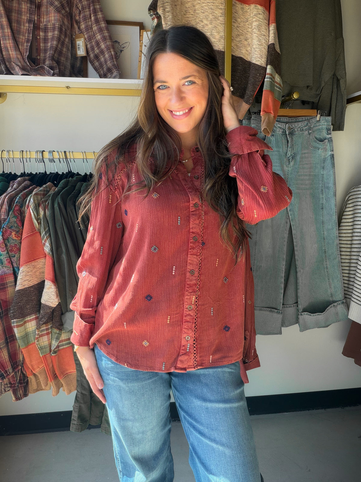 Tru Luxe Jeans

Rich dark rust and rich in detail, this button-up shirt is covered in tiny embroidered motifs that add texture and dimension to a timeless silhouette. Lightweight rayon gives it a soft hand and a graceful drape.

A classic collar, full button front, and buttoned cuffs keep it polished, while the curved shirttail hem makes it easy to wear untucked. It looks just as good over leggings as it does with dark denim and ankle boots.

Style #: T46225BM
Fabric Content: 100% Rayon
Length: 28.5" front 