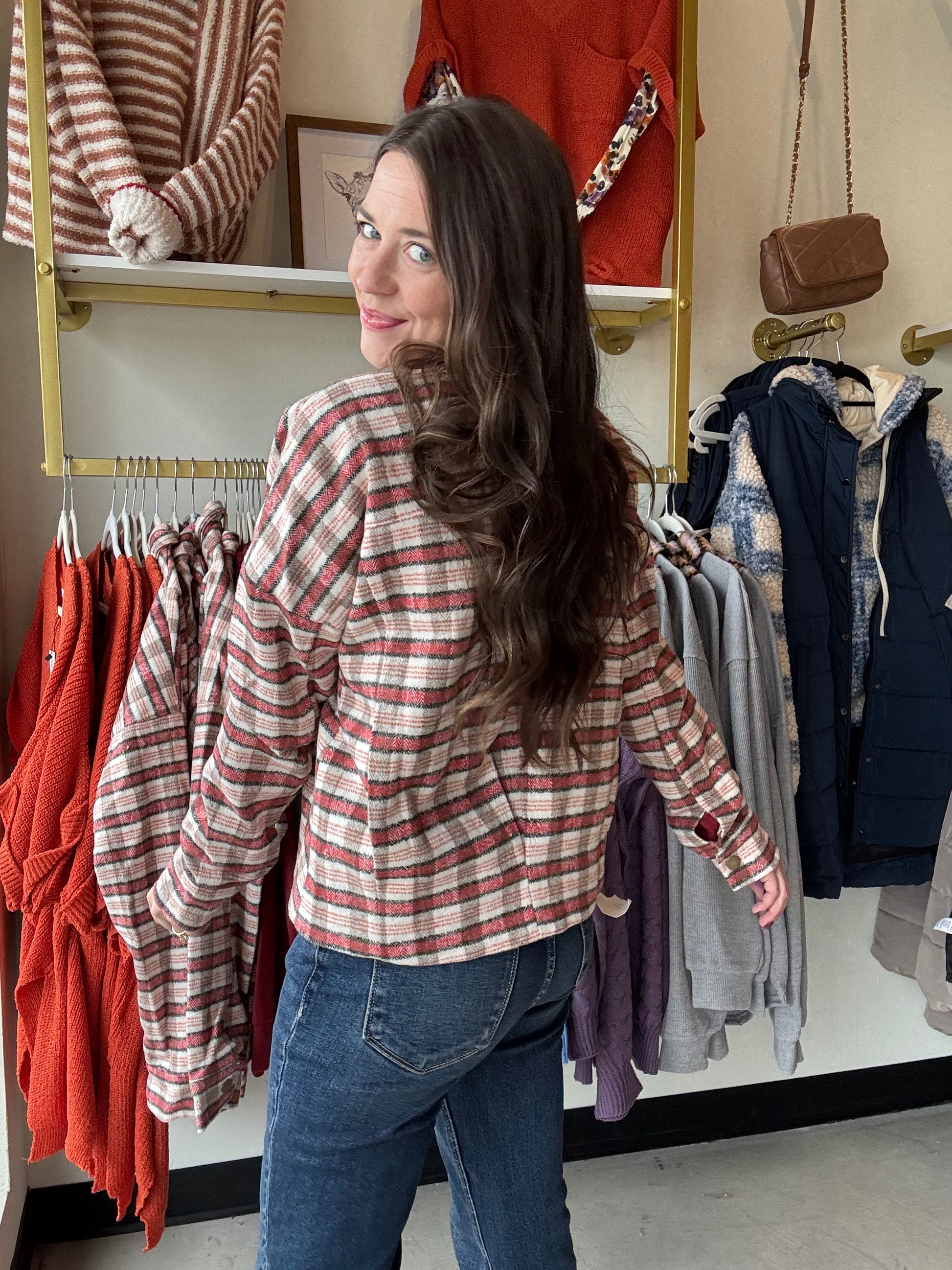 The Rust &amp; Mocha Plaid Jacket features a fully lined interior, ensuring comfort and durability throughout the season. Its boxy fit provides a modern silhouette while allowing ease of movement. Designed in rich fall tones of rust and mocha, this jacket effortlessly complements autumn wardrobes. Practical front pockets add functionality without compromising style, making it an essential outerwear piece for transitional weather.