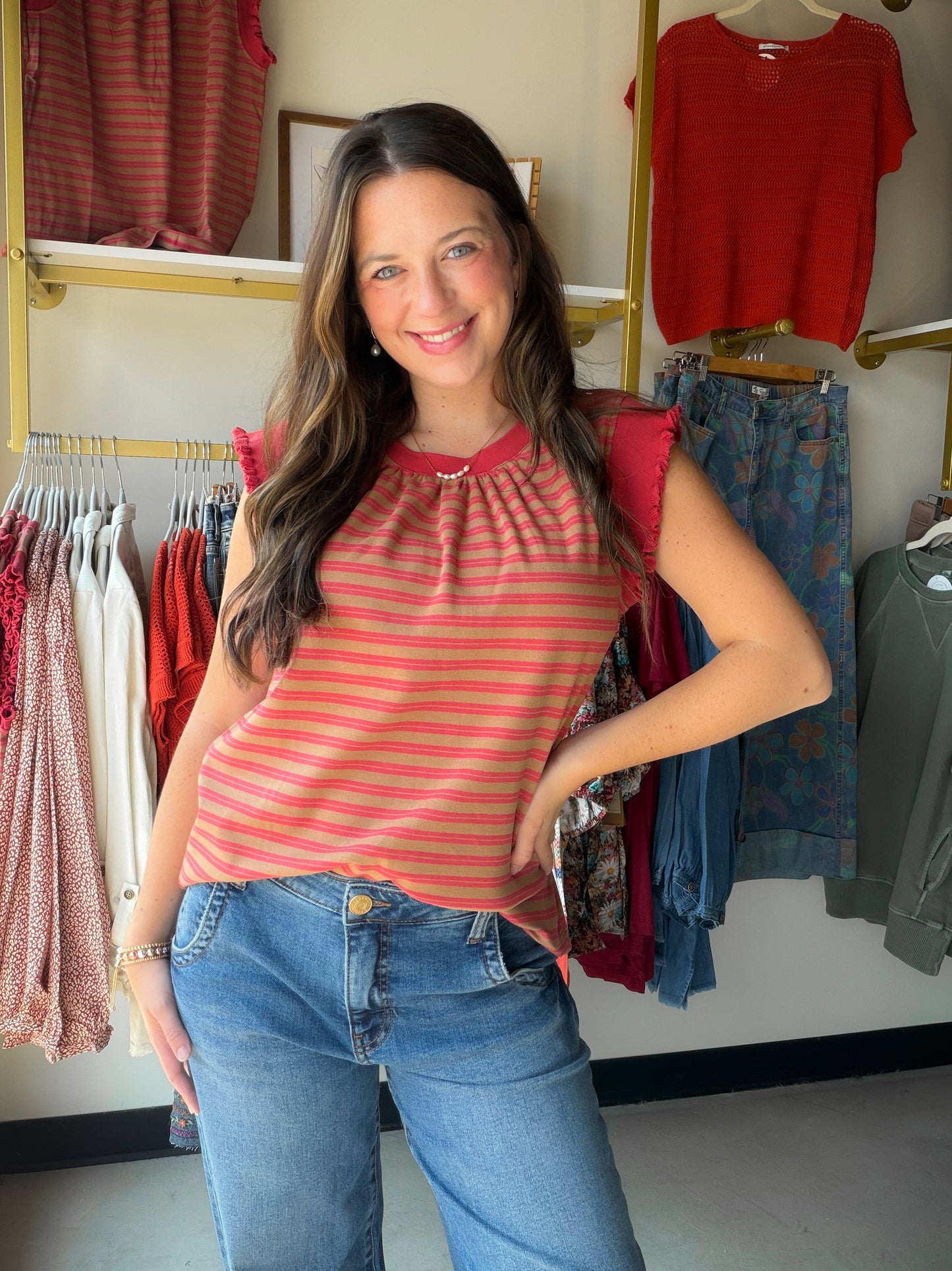 A warm rust stripe meets playful ruffle-knit texture in this easy sleeveless top. The banded hem and crew neckline give it a polished finish, while the cotton-blend fabric keeps it comfortable and breathable all day. Dress it up with white denim or keep it casual — either way, it's a warm-weather win.

Sleeveless crew neck silhouette
Ruffle knit texture with stripe detail
Banded hem for a clean, flattering finish
95% Cotton, 5% Spandex — soft with a hint of stretch
Easy to style up or down