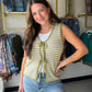 The Sage Stripe Crochet Sweater Vest by Staccato is the kind of piece that instantly elevates any outfit. Crochet striping in a fresh sage palette brings artisan texture and laid-back charm, while the double bow-tie front and V-neckline add a sweet, feminine finish.

Made from a 60% Cotton, 40% Acrylic blend, it's lightweight yet structured — perfect for layering over a fitted tee, a flowy blouse, or your favorite long-sleeve. Style it open for a relaxed cardigan vibe or tied for a more defined look.
