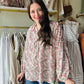 This Slate Rose Floral Blouse features a beautiful V-neck and long sleeves, with a self-tie at the neck for added style. The elastic cuffs provide a comfortable fit, while the lightweight woven material keeps you cool. Perfect for any occasion, this blouse is non-sheer and unlined for a polished look.