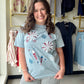 Grace &amp; Emma

Celebrate in style with this shimmering fireworks graphic tee, featuring a festive sparkle and an ultra-comfortable relaxed fit. Crafted from 100% breathable cotton, it’s the ultimate high-impact top for every summer barbecue and holiday parade.

Breathable 100% cotton for all-day comfort.
Eye-catching shimmer and glitter firework details.
Relaxed, oversized fit for effortless style.
Festive red, white, and blue graphics.
Classic crew neck for versatile wear.
Durable fabric with a soft str