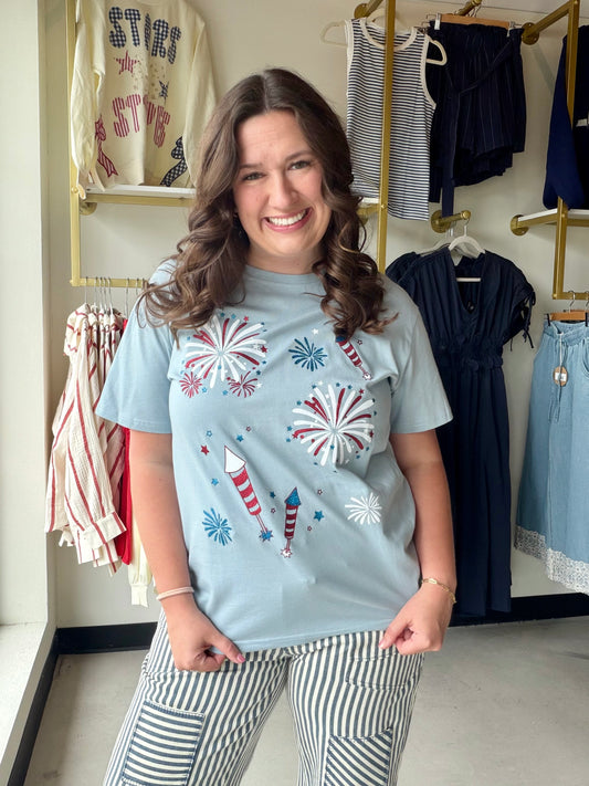 Grace &amp; Emma

Celebrate in style with this shimmering fireworks graphic tee, featuring a festive sparkle and an ultra-comfortable relaxed fit. Crafted from 100% breathable cotton, it’s the ultimate high-impact top for every summer barbecue and holiday parade.

Breathable 100% cotton for all-day comfort.
Eye-catching shimmer and glitter firework details.
Relaxed, oversized fit for effortless style.
Festive red, white, and blue graphics.
Classic crew neck for versatile wear.
Durable fabric with a soft str