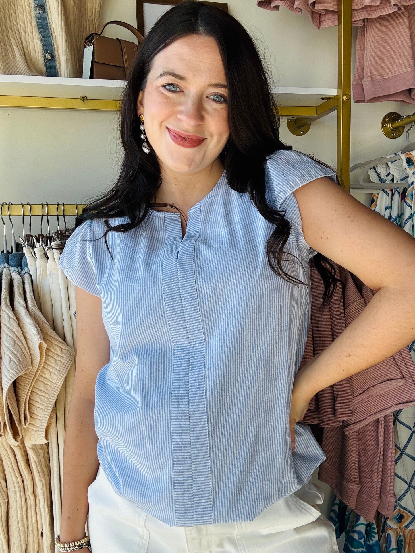 Jess Lea

This top is a statement piece that reflects your unique style and confidence. Whether you're heading to a business meeting or a brunch with friends, this top ensures you look effortlessly stylish. The For The Record Pinstripe Top features a pinstripe pattern and ruffle sleeves.
