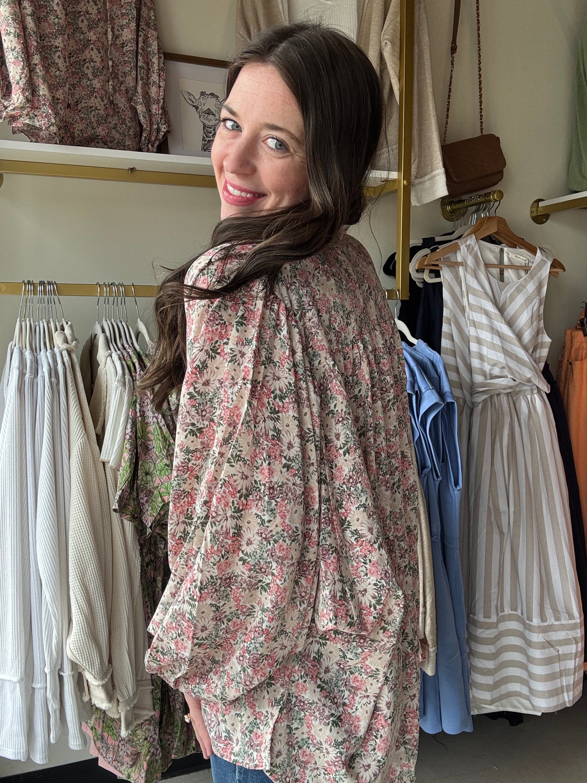 This Slate Rose Floral Blouse features a beautiful V-neck and long sleeves, with a self-tie at the neck for added style. The elastic cuffs provide a comfortable fit, while the lightweight woven material keeps you cool. Perfect for any occasion, this blouse is non-sheer and unlined for a polished look.