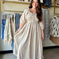 The dress that does the talking. The Natural Smocking Midi Dress is everything a warm-weather dress should be — effortless, feminine, and just a little bit dreamy.

A smocked bodice hugs the body beautifully before flowing into a full, lined midi skirt that moves with you. Volume sleeves and a ruffled neckline bring the romantic detail, while an adjustable tie at the bustline lets you customize the fit to perfection. The flowy cotton-blend fabric keeps it light and breathable all day long.

Dress it up with