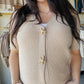 Elevate your casual wardrobe with this charming taupe waffle sweater cardigan. Featuring a classic v-neck, decorative starfish buttons, and comfortable half sleeves, this piece offers effortless style for any season. The textured waffle knit adds visual interest while maintaining a timeless, versatile look that pairs beautifully with jeans, skirts, or layered outfits. Perfect for layering or wearing solo.