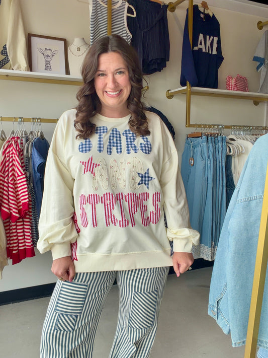 Bibi

Celebrate in style with this premium Bibi French terry sweatshirt featuring vintage-inspired "Stars and Stripes" patchwork and a trendy gingham side-bow accent. This oversized Americana pullover combines ultimate comfort with a festive, boutique-quality design perfect for 4th of July festivities.

Soft premium French terry fabric.
Charming blue gingham side-bow detail.
Unique mixed-print vintage patchwork lettering.
Relaxed, oversized fit for comfort.
Festive Americana stars and stripes.
High-quality 