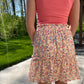 This Summer Garden Tiered Skirt is perfect for both office and leisure situations. The skirt features an elastic waist for comfort and light weight fabric for breathability and ease. With its modest length and feminine style, you can stay cool and classy throughout the day.