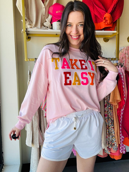 Jess Lea&nbsp;

Say goodbye to boring pullovers and hello to the Take It Easy Patch Pullover! The ribbed hem, cuffs, and collar add to this playful piece. Features chenille patches outlined in sequins. Perfect for adding a pop of personality to any outfit.