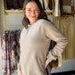 Meet your new go-to layering piece from&nbsp;Doe &amp; Rae. This fleece crewneck sweatshirt brings a modern edge to everyday comfort with its asymmetric hemline and roomy front pockets — the kind of piece you reach for on repeat.

Asymmetric hemline for an effortlessly elevated, fashion-forward silhouette
Front pockets — functional and stylish
Oversized, relaxed fit perfect for layering over denim or leggings
Soft fleece fabric: 60% Cotton / 40% Polyester blend
Warm, neutral taupe colorway that pairs with e