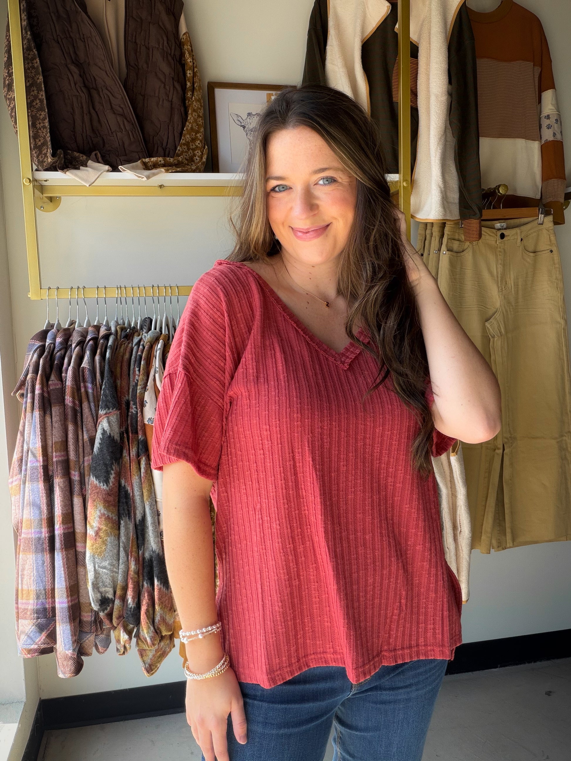 The perfect warm-toned essential. The Terracotta Ribbed V-Neck Tee from POL is the kind of top that works harder than it looks — a relaxed, roomy silhouette with a textured ribbed knit, flattering V-neckline, and thoughtful details that elevate a simple short sleeve.

An extended back hem adds coverage and movement, while the exaggerated side slits give it that effortless, fashion-forward edge. Wear it tucked, half-tucked, or let it flow — it's endlessly versatile.

V-neckline with short sleeves
Roomy, over