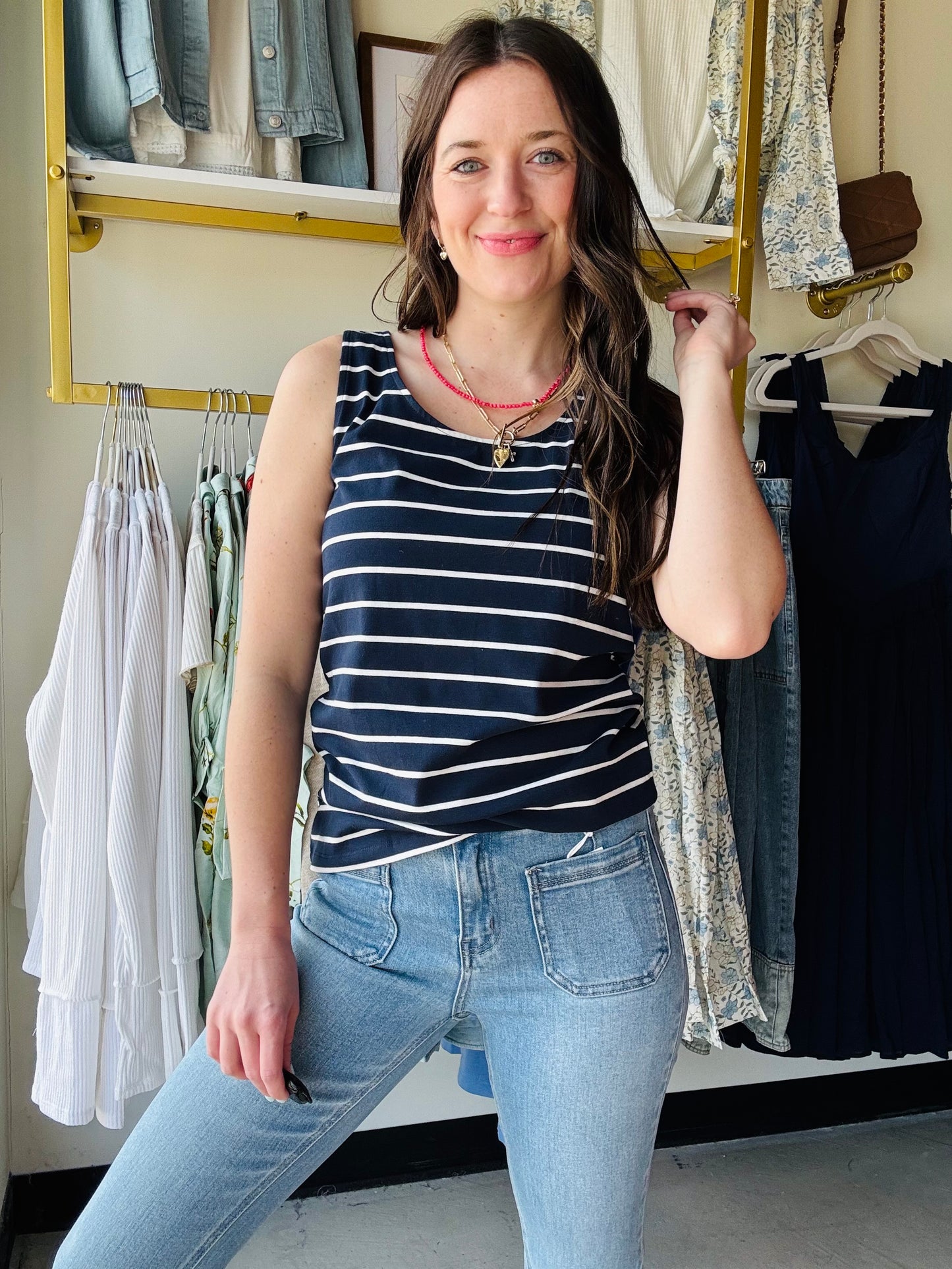 Meet Tiffany! She'll quickly become one of your favorites and go-to tanks all year! The fabric is lightweight and breathable, with amazing stretch. It's also wide enough to wear your favorite bra and has a flattering scoop design along the front and back of the tank.&nbsp;

Fit: True to size with high stretch
Fabric: 60% polyester, 35% rayon, 5% spandex&nbsp;
Model Sizing: Catherine is wearing a small