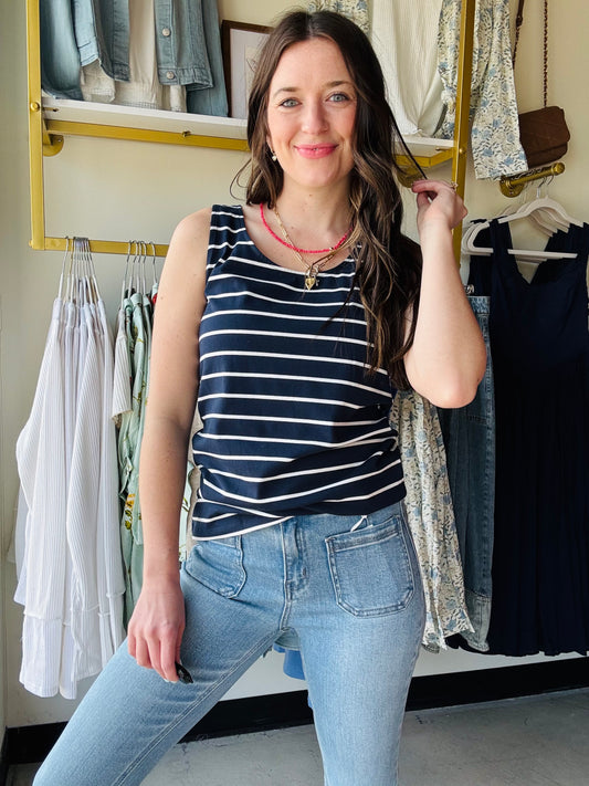 Meet Tiffany! She'll quickly become one of your favorites and go-to tanks all year! The fabric is lightweight and breathable, with amazing stretch. It's also wide enough to wear your favorite bra and has a flattering scoop design along the front and back of the tank.&nbsp;

Fit: True to size with high stretch
Fabric: 60% polyester, 35% rayon, 5% spandex&nbsp;
Model Sizing: Catherine is wearing a small
