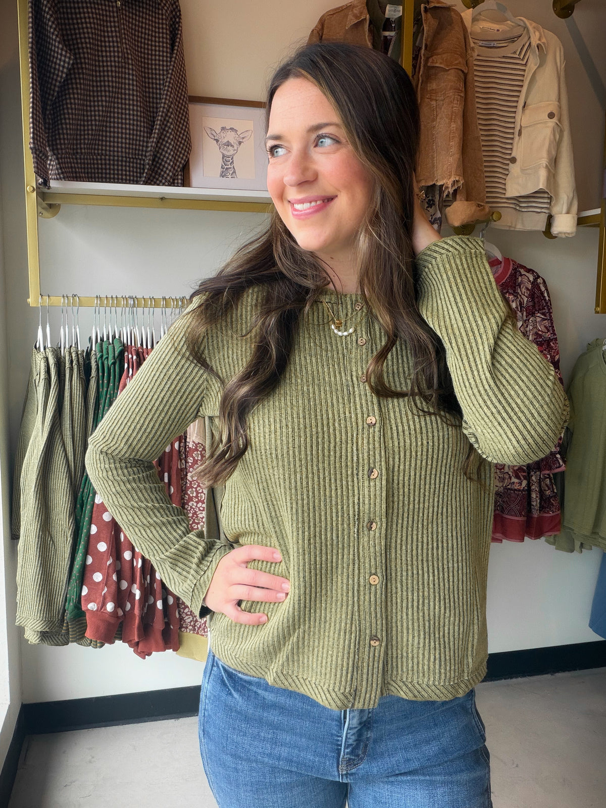 Classic stripes, modern ease — this knit button-up from&nbsp;Tru Luxe Jeans is the kind of piece that works with everything already hanging in your closet. The rich olive hue and ribbed texture give it a polished, put-together feel whether you tuck it in or wear it loose.

Stripe knit button-up silhouette
Ribbed texture for added dimension and structure
Long sleeve design for effortless layering or standalone wear
Polyester/Spandex blend for comfortable stretch
Available in sizes S–XL