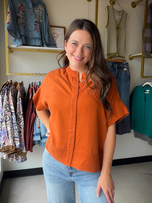 Elevated basics just got an upgrade. The Button Trapunto Stitch Top features raised trapunto stitch detailing that adds a subtle, dimensional texture you won't find anywhere else. Crafted in soft, flowing Lyocell, it drapes beautifully and strikes the perfect balance between polished and effortless — ideal for the office, a lunch date, or a weekend out.

Button front silhouette with trapunto stitch detail
Dimensional raised stitching for a unique, textured finish
Rich rust colorway
Lyocell fabric — soft, br