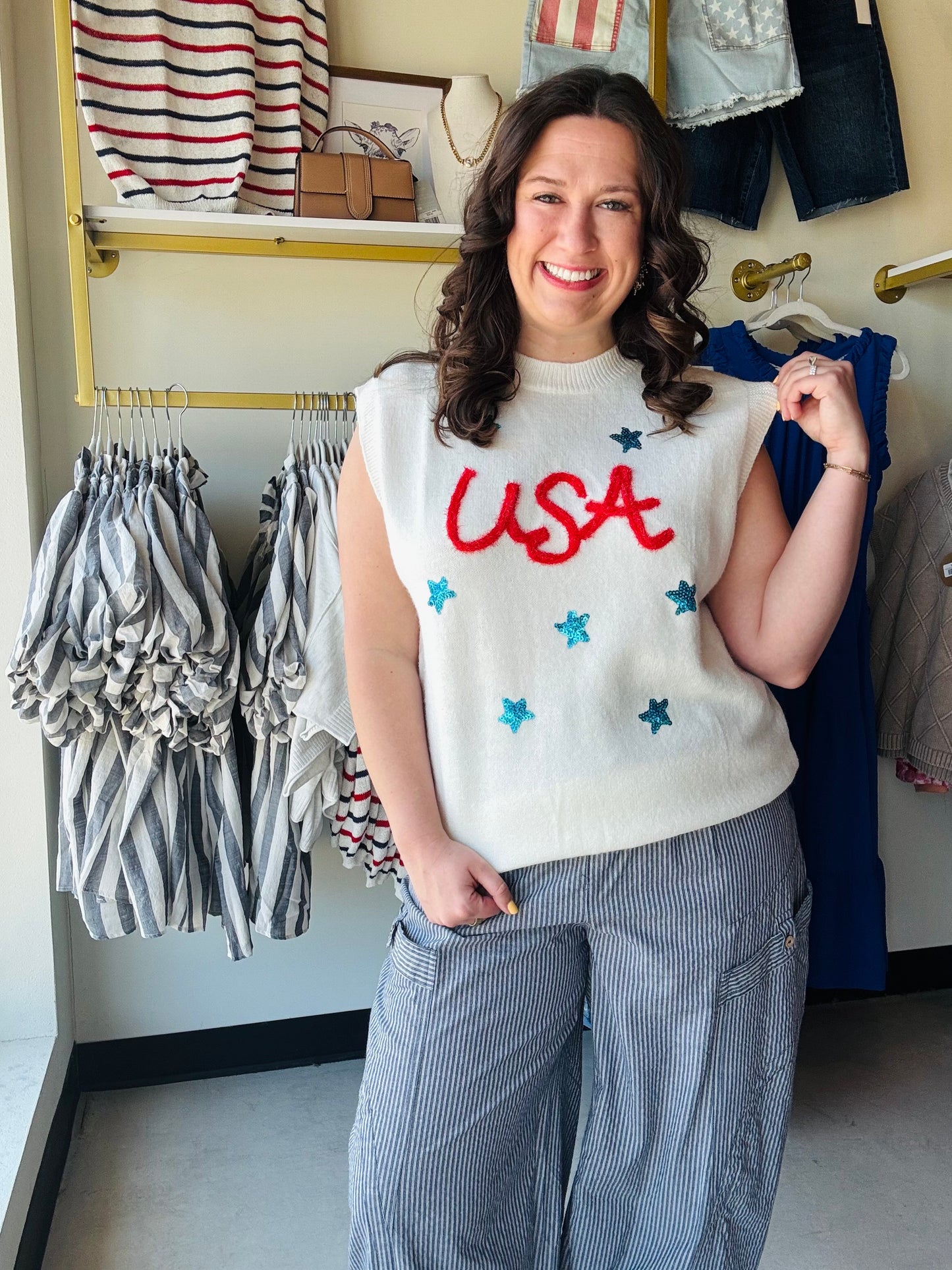 Jess Lea

Shine bright this Independence Day in our festive USA tinsel sweater vest. Featuring bold red textured lettering and shimmering blue sequin stars, this lightweight knit is the ultimate patriotic statement piece for parades, parties, and summer celebrations.

Shimmering blue sequin star accents
Bold red tinsel USA lettering
Lightweight knit for summer comfort
Versatile sleeveless layering piece
Perfect for July 4th festivities
Vibrant, photo-ready patriotic style
Soft, breathable premium fabric ble