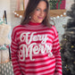 A Very Merry Pop of Pink

Give your holiday wardrobe a playful twist with the Pink Stripe Jacquard Merry Sweater by Staccato. Pink stripes and festive “Very Merry” jacquard lettering bring Christmas cheer to a classic crewneck silhouette, making this a sweet pick for seasonal plans that call for something a little more fun.

Picture a peppermint coffee in hand, an afternoon browsing for gifts, and this sweater paired with your favorite denim. Long sleeves and a soft cotton blend make it an easy piece to bui