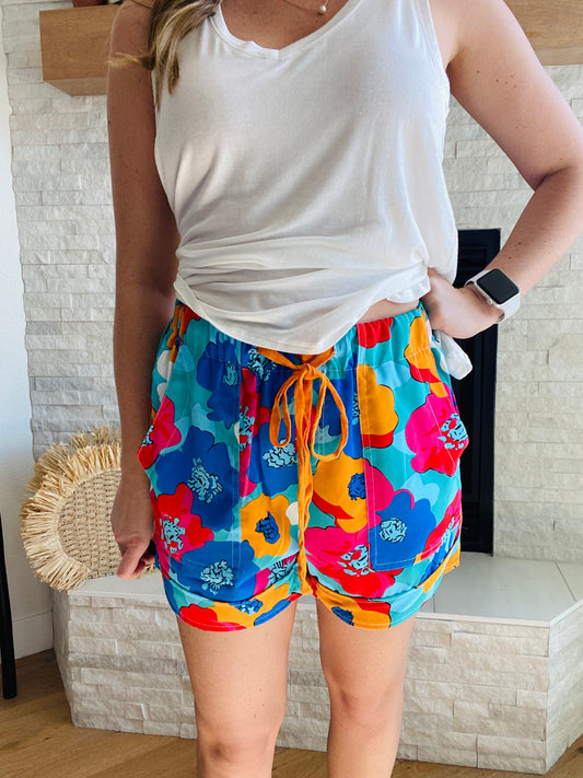 Our Abstract Floral Everyday Shorts feature a relaxed, breezy feel and a vibrant color palette for a stylish look this summer. With a drawstring elastic waistband for a comfortable feel, they pair perfectly with a white tank and a denim jacket.  100% Polyester