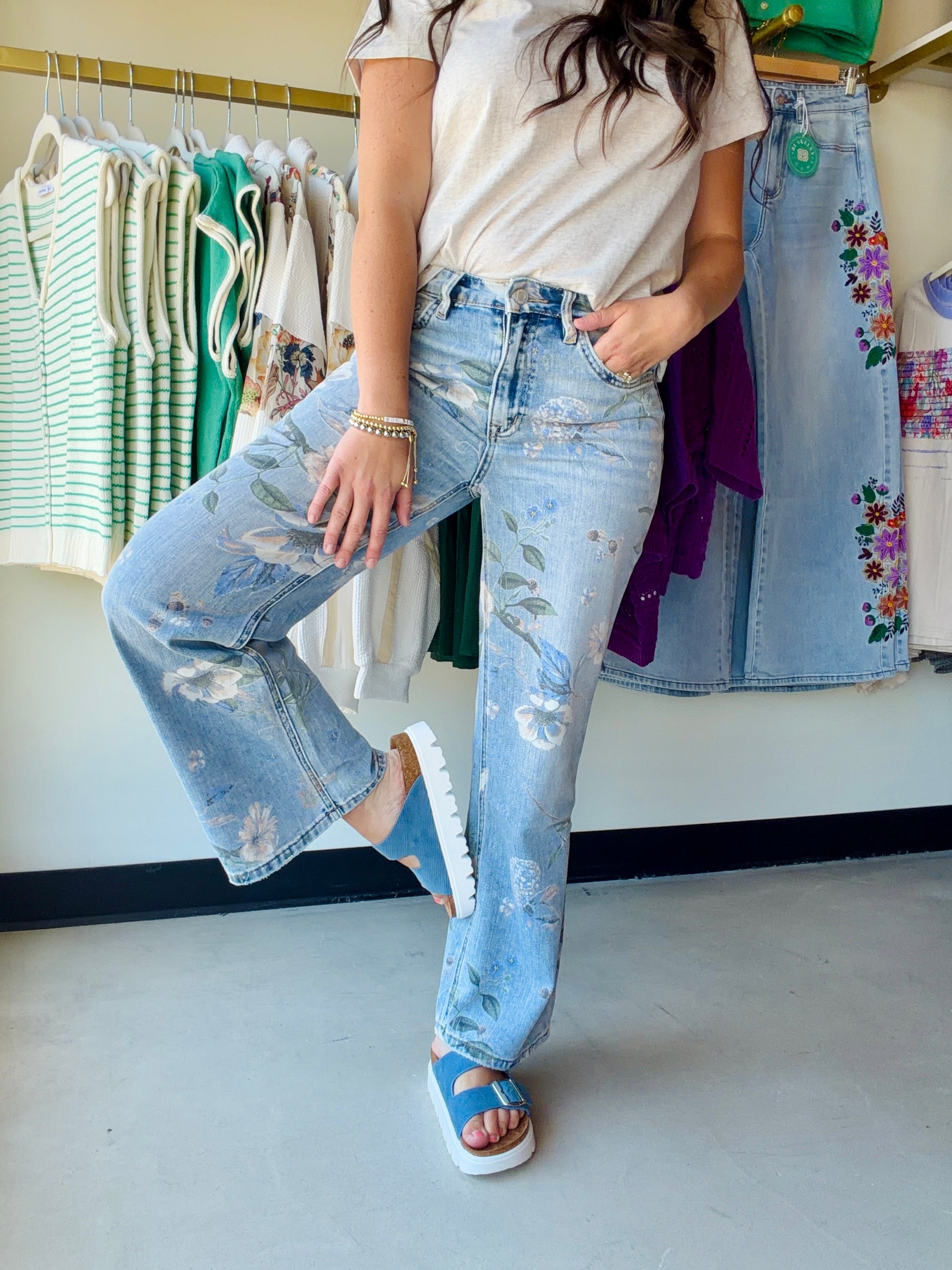 Meet your new favorite statement denim. The Vintage Floral High Rise Wide Leg by Vervet by Flying Monkey combines a bold floral print with a super high-rise waist and extreme vintage flare silhouette — effortlessly editorial, undeniably cool.

Crafted in non-stretch denim for a structured, vintage-authentic feel, these jeans feature a flattering 11" front rise, five-pocket styling, a finished hem, and a sweeping 22" leg opening that commands attention.

Super high-rise waist (11" front rise)
Extreme vintage