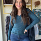 Embrace cozy charm with this Dark Teal Button V Neck! Featuring a flattering V-neckline and two cute buttons, its ribbed texture adds playful detail. The long sleeves and relaxed fitted silhouette make it perfect for layering or solo style moments. Imported for a unique touch, this top pairs effortlessly with your favorite jeans or skirts for an easygoing, fun vibe.

Yelete&nbsp;