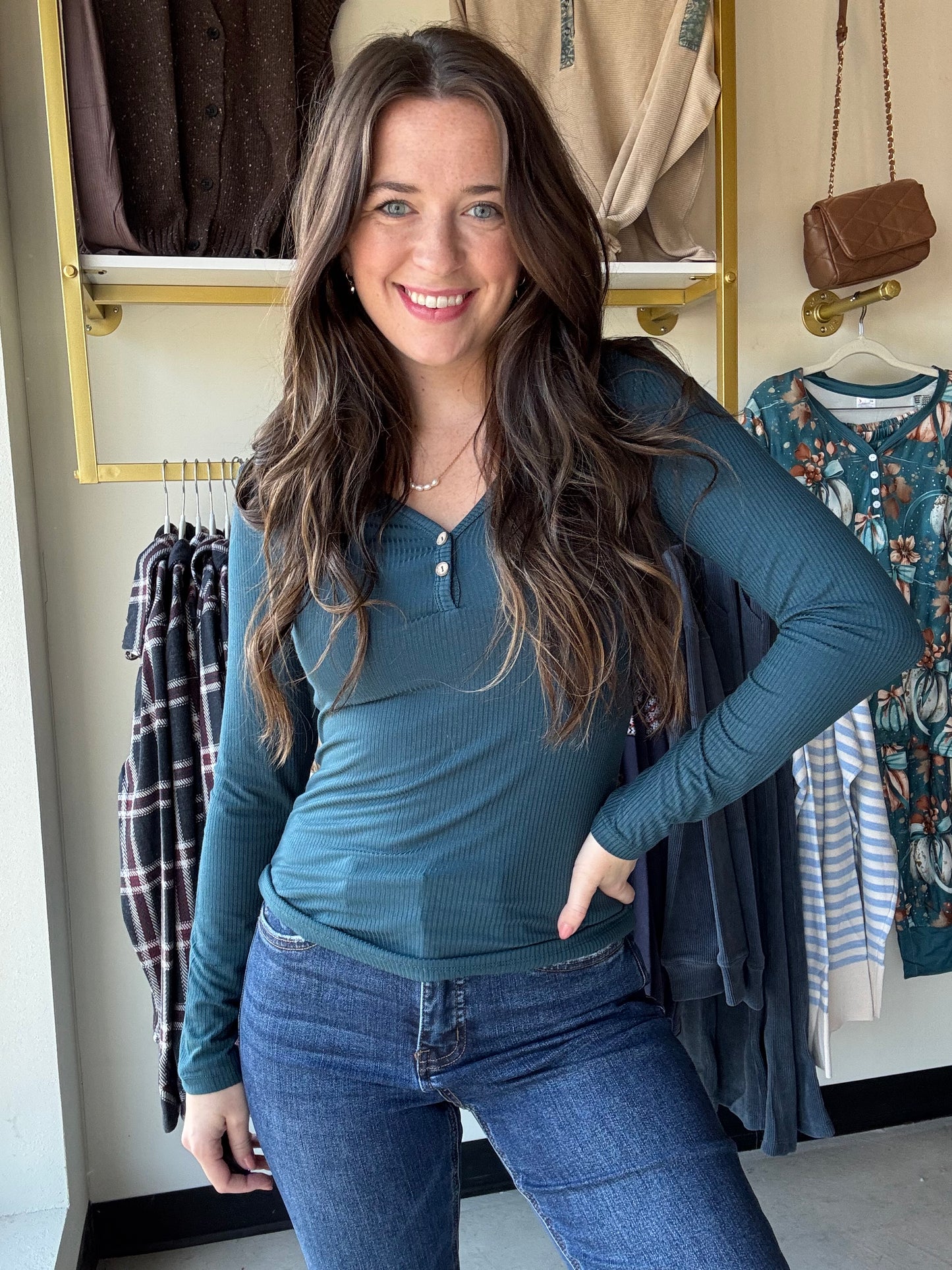 Embrace cozy charm with this Dark Teal Button V Neck! Featuring a flattering V-neckline and two cute buttons, its ribbed texture adds playful detail. The long sleeves and relaxed fitted silhouette make it perfect for layering or solo style moments. Imported for a unique touch, this top pairs effortlessly with your favorite jeans or skirts for an easygoing, fun vibe.

Yelete&nbsp;