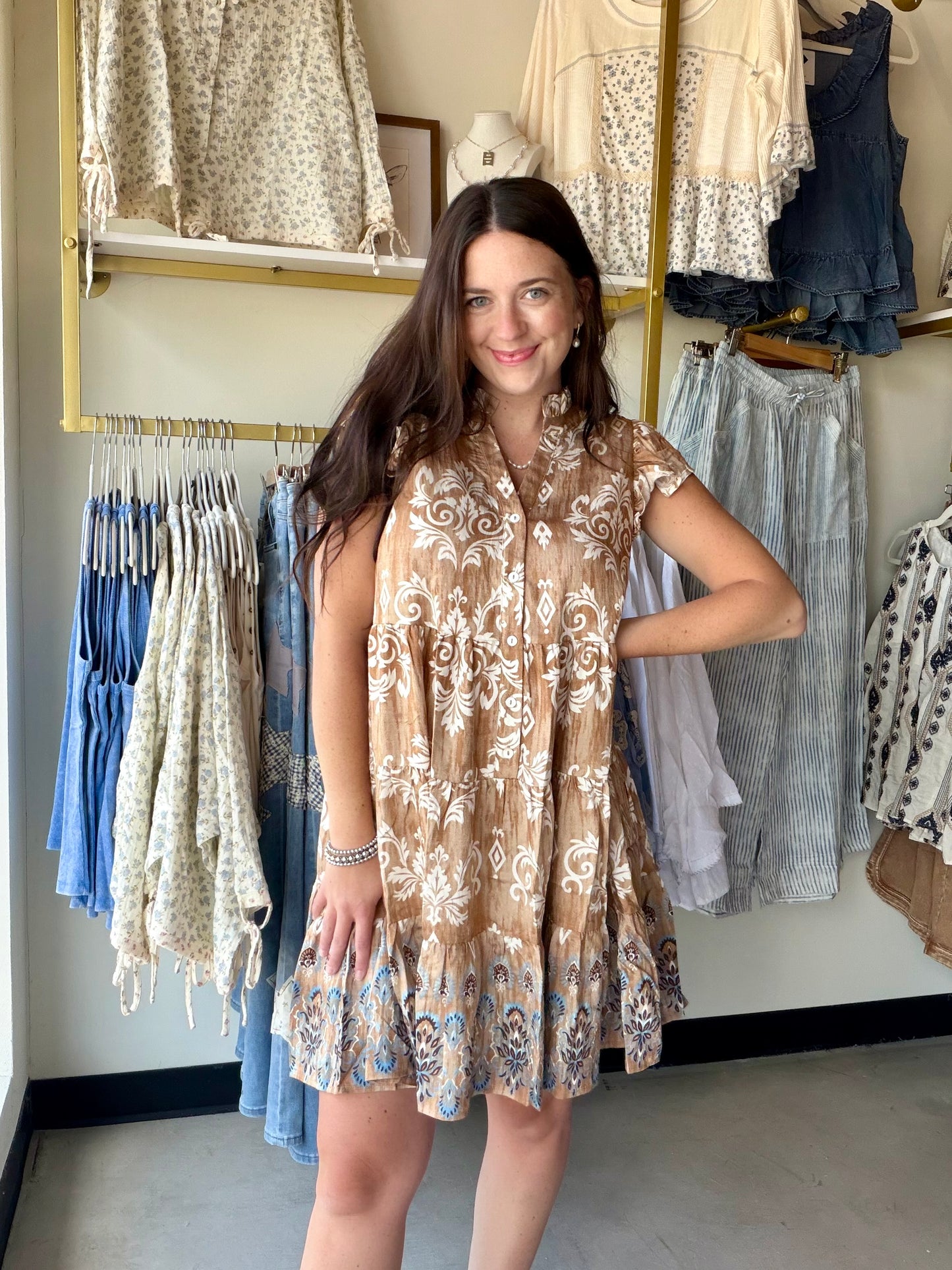 Hem &amp; Thread&nbsp;

A dress that feels like a vacation. The Mocha Vintage Border Tiered Dress is a mini with major personality — a vintage-inspired border print flows through each tiered layer, giving it that effortlessly cool, retro-boho energy that's impossible to replicate.

Flutter sleeves and a flattering V-neckline keep it feminine and breezy, while the soft rayon-blend fabric drapes beautifully and feels lightweight against the skin. The tiered silhouette adds movement and volume that looks stunn