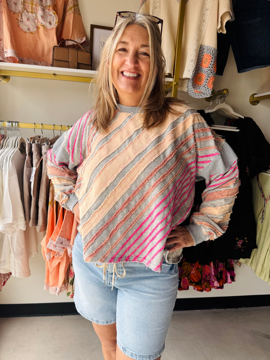 Oli &amp; Hali

Experience the perfect blend of vintage charm and modern boho-style with this uniquely textured statement piece. Featuring raw-edge diagonal stripes and a bold "LOVE" back patch, this mineral-washed pullover delivers an effortlessly cool, lived-in look. It’s the ultimate cozy layer for those who want to wear their heart on their sleeve (and their back).

Vintage-inspired mineral wash finish.
Edgy raw-edge striped detailing.
Effortless, oversized relaxed fit.
Bold "LOVE" graphic back patch.
B