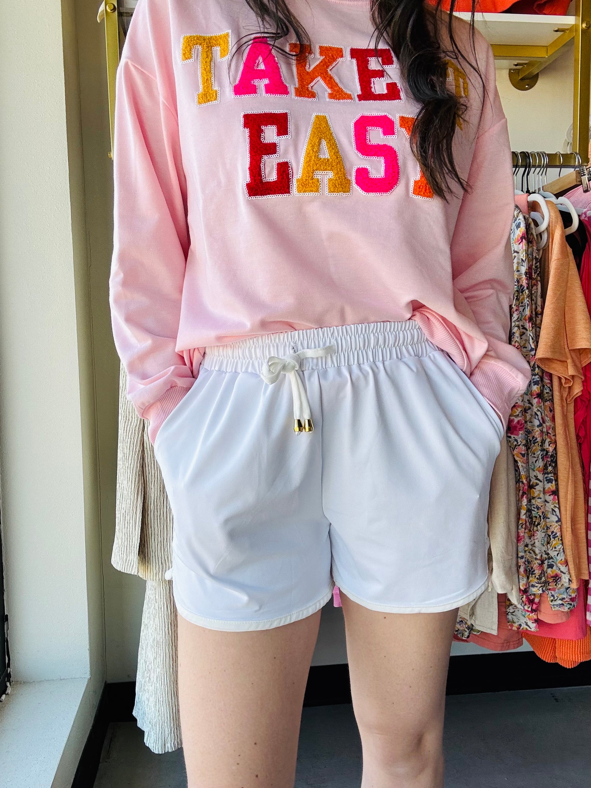 Jess Lea

These mid-rise solid white shorts are so perfect for the spring and summer and even to wear into the fall! Get the effortless yet chic look with these shorts. They feature a mid-rise, tie waist drawstring, &amp; side pockets. These are a relaxed fit.