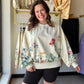 Easel

Bloom with effortless style in this stunning watercolor floral pullover, featuring a vintage-inspired mineral wash. The relaxed dolman fit provides all-day comfort while the artistic print adds a soft, feminine touch to your everyday look.

Flattering, oversized relaxed fit
Trendy vintage mineral wash finish
Artistic hand-painted watercolor floral print
Easy-moving, stylish dolman sleeves
Soft, breathable premium washed terry
Effortless transition from home to out
Timeless and classic round neckline
