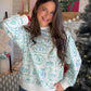 A Blue Christmas, in the Best Way

Make room for a little holiday cheer with the Sarah Yuletide Blue Sweatshirt by Mary Square. This seasonal sweatshirt brings a fresh blue touch to your holiday wardrobe, ready to style for gift-shopping afternoons, casual get-togethers, and evenings spent watching your favorite Christmas movies.

The polyester-spandex blend includes a touch of stretch, making it a lovely choice for those days when your plans take you from one festive stop to the next. Slip it on with denim