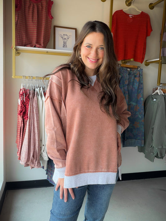 Bold color meets effortless comfort. The&nbsp;Acid Wash Pullover by Zenana is a cozy fleece pullover with serious personality. The rich rust hue gets an artisan edge from the acid wash treatment, meaning every piece is one-of-a-kind — no two are exactly alike. Contrast trim detailing and side slits add thoughtful finishing touches that keep it feeling fresh and fashion-forward.

Made from a soft cotton-poly fleece blend, it's the kind of pullover you'll live in all season long. Oversized and relaxed, it pai