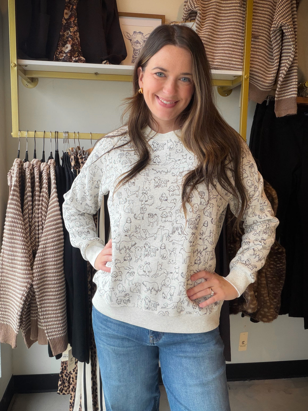 A little puppy personality makes an everyday outfit more fun. The Dog Sketch Sweatshirt by SM Wardrobe brings a dog-inspired sketch theme to your casual wardrobe, paired with a fleece-lined interior for those cozy-day plans. Whether you’re a proud dog mom or simply can’t resist a four-legged friend, this one adds a playful touch to your sweatshirt rotation.

Picture a slow morning with coffee, your favorite jeans, and your pup waiting by the door. Slip this sweatshirt into your weekend lineup for a neighbor