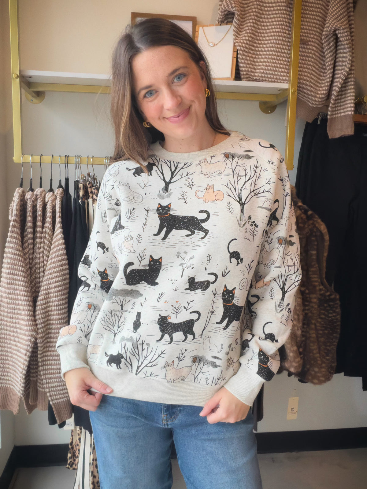 For the cat lover with a soft spot for storybook charm, the Whimsical Cat Forest Sweatshirt by SM Wardrobe brings a playful touch to your casual wardrobe. Its cat-and-forest theme gives your everyday look a little personality, while a fleece-lined interior adds an inviting layer for those stay-cozy kind of days.

Imagine a leisurely morning with your favorite mug, a good book, and nowhere to rush. Then, when the afternoon calls for a coffee date or a stroll through town, pair this sweatshirt with your go-to
