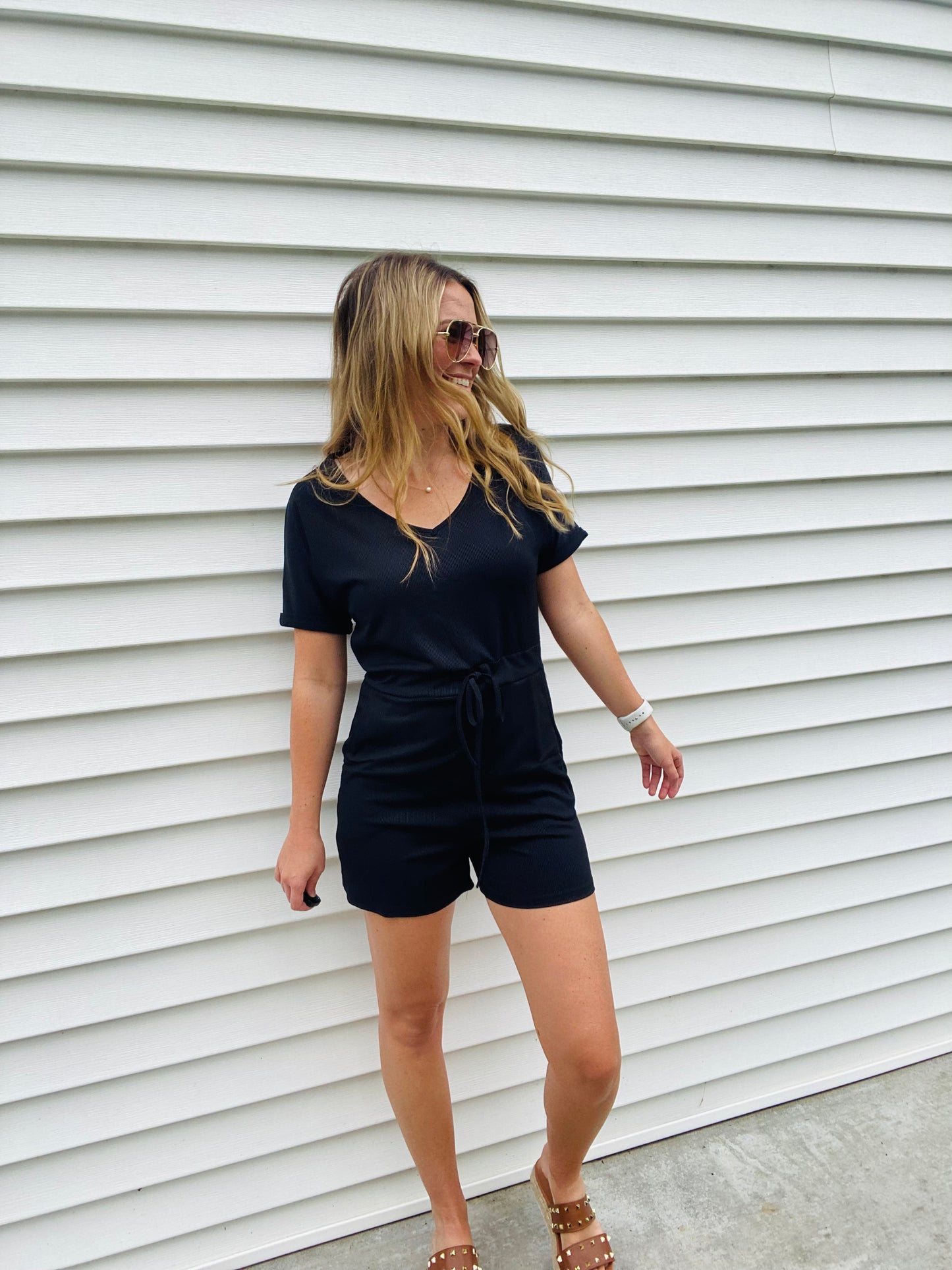 This Black Ribbed Abby Romper offers all-day comfort and style. Made of a lightweight fabric, it features a drawstring waistband, scoop neck neckline, and a casual, cute look. Perfect for pairing with a blazer or jean jacket and sneakers. Enjoy effortless style and comfort.