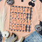 T-shirt with 'Take me to the pumpkin patch' design on a checkered background, surrounded by Halloween-themed accessories.