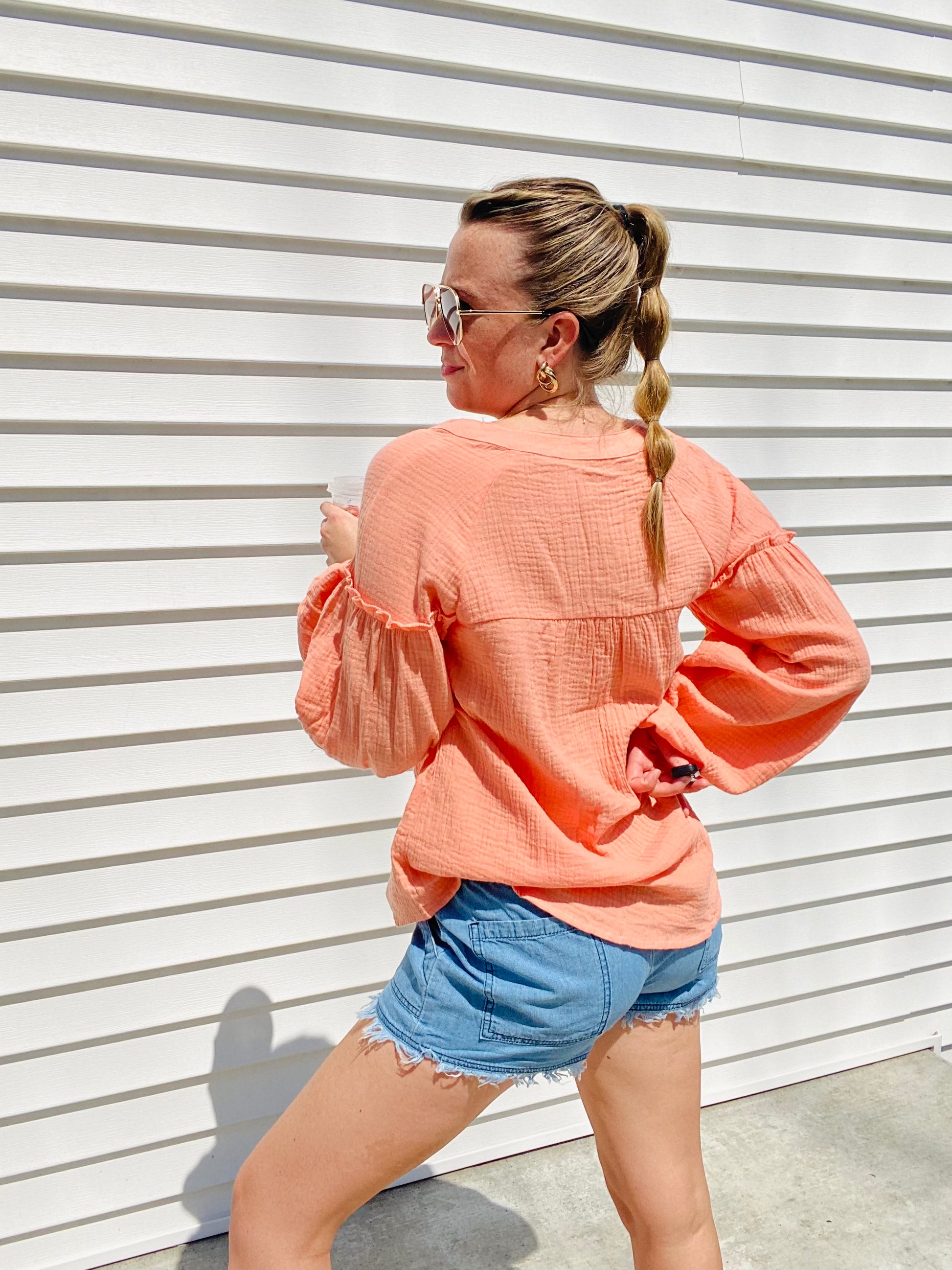 The Coral Love Gauzy Crinkle Top is the perfect addition to your wardrobe. Featuring casual balloon sleeves and functioning buttons, this top is ideal for achieving a relaxed yet stylish look. Wear it with denim and sandals for an effortless yet cute outfit.