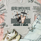 Gray t-shirt with coffee graphic and text, paired with sneakers and denim jacket on a pink background.